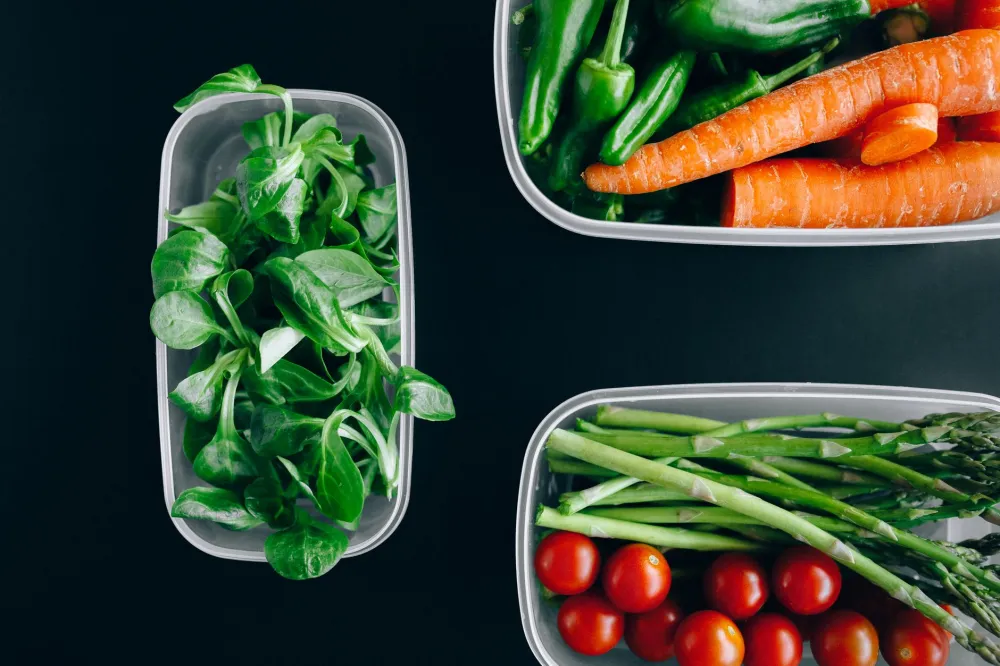 Healthy meal prep containers supporting a weight loss exercise routine with nutrition