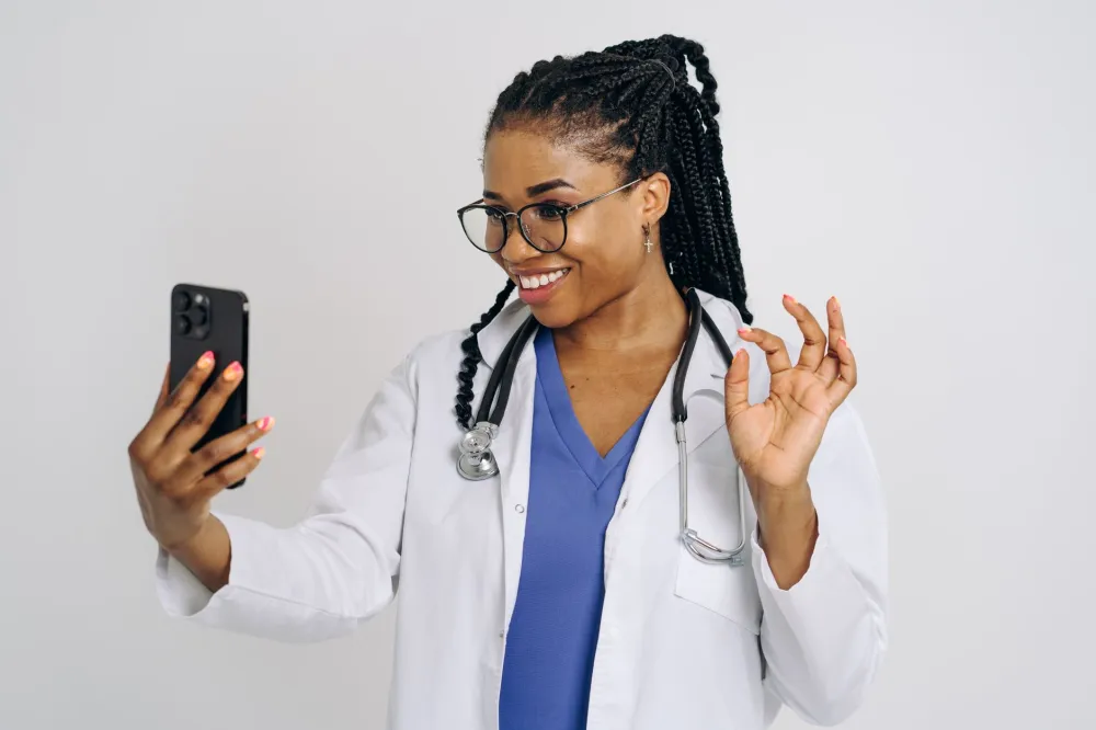 Woman on phone scheduling medical appointments, illustrating the hidden burden of navigating healthcare