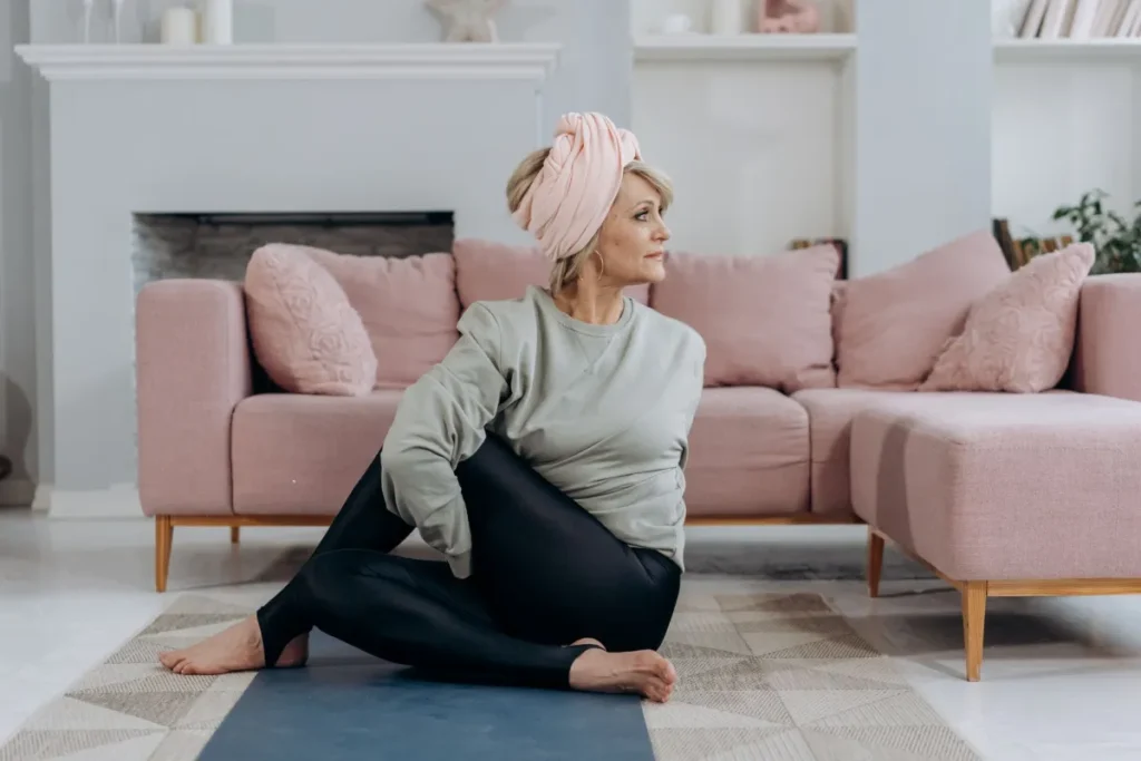 Woman practicing beginner yoga poses on a mat in a bright living room at home