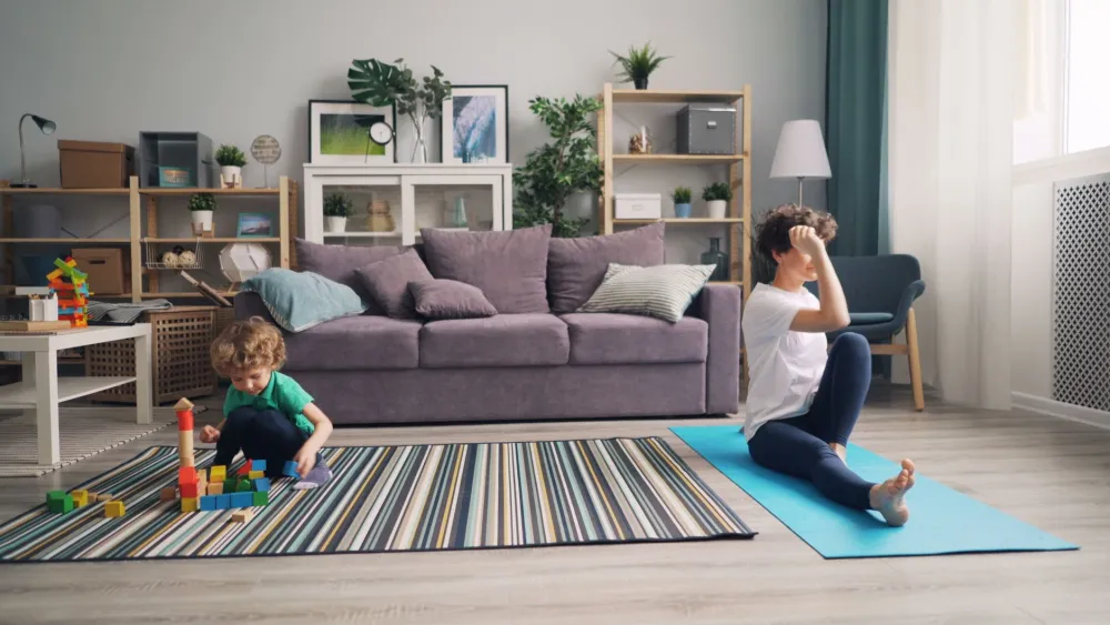 Yoga Poses That Ease Lower Back Tension: What Works 5 Yoga mat laid out in bright living room ready for lower back tension practice