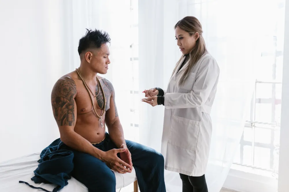 Doctor explaining the common causes of acne on penis to a male patient