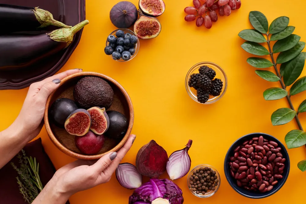 Bowl of anti-inflammatory foods including leafy greens and berries for breast pain relief