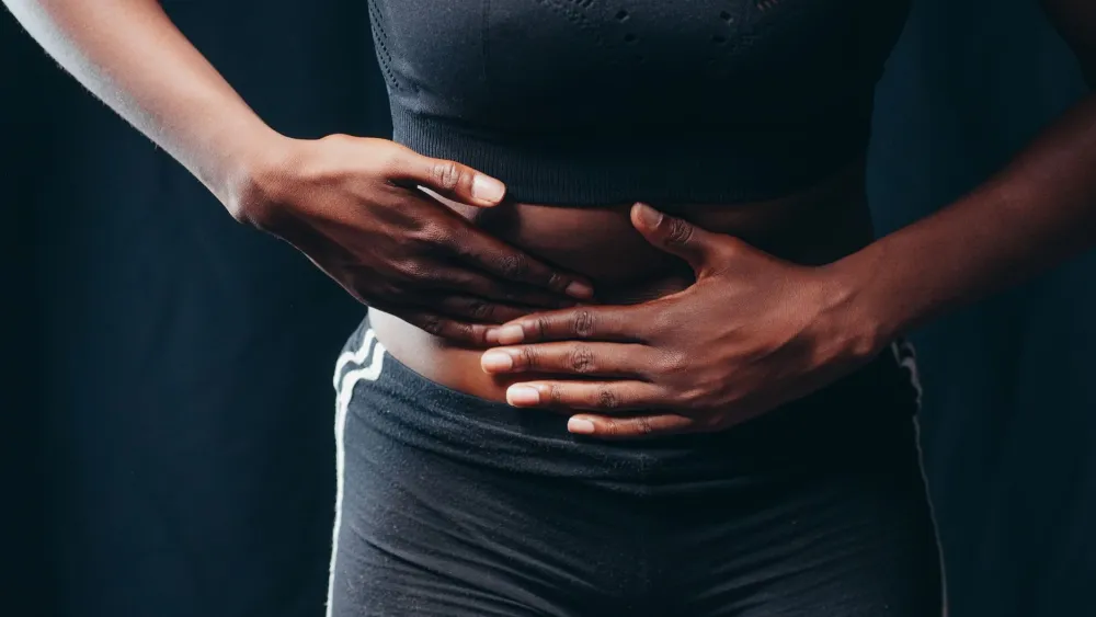 CoolSculpting Side Effects: Normal vs Rare Warning Signs 2 Woman gently checking her belly for common CoolSculpting side effects like swelling