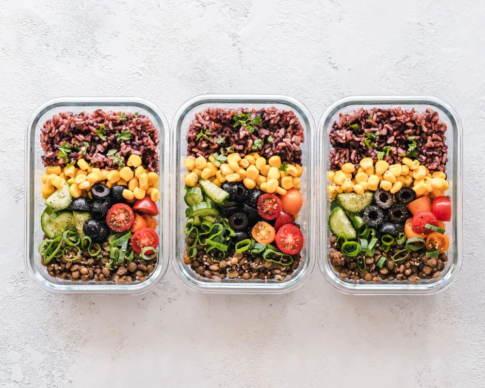 Meal prep containers with balanced whole foods to support a low added sugar diet