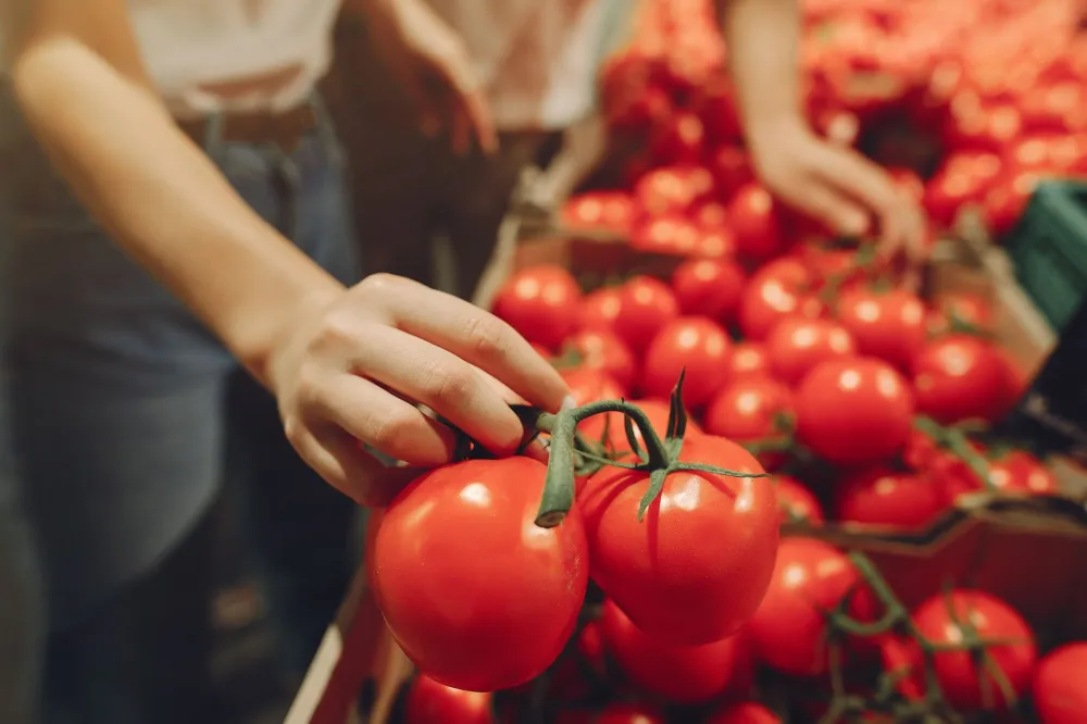 Person choosing fresh whole foods at a grocery store for a clean keto diet