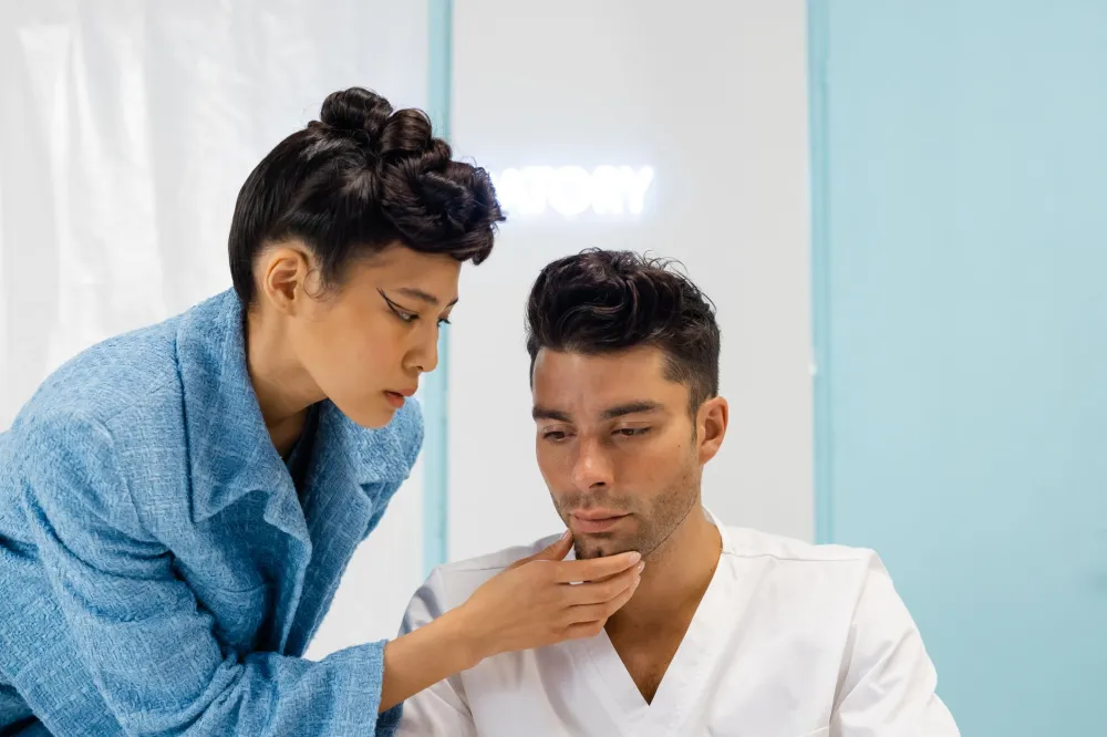 Dermatologist examining a patient's facial skin during a clinical consultation