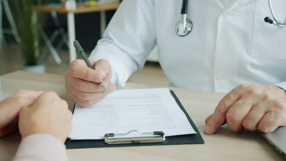 Male patient talking with a doctor about genital bumps and HPV vaccination