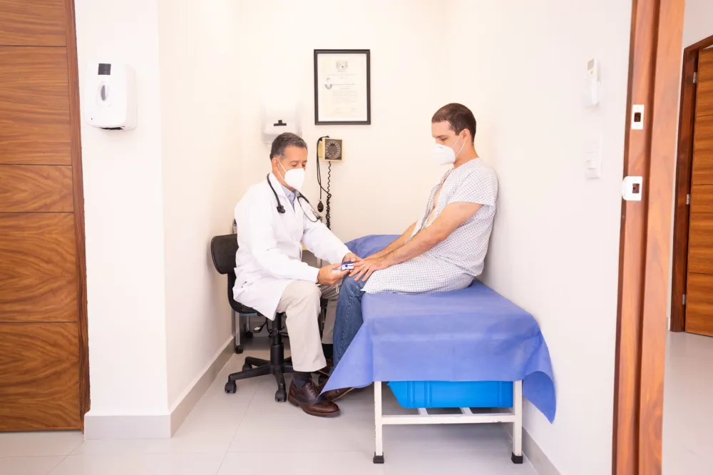 Doctor talking with a young adult patient about bruising that won't fade