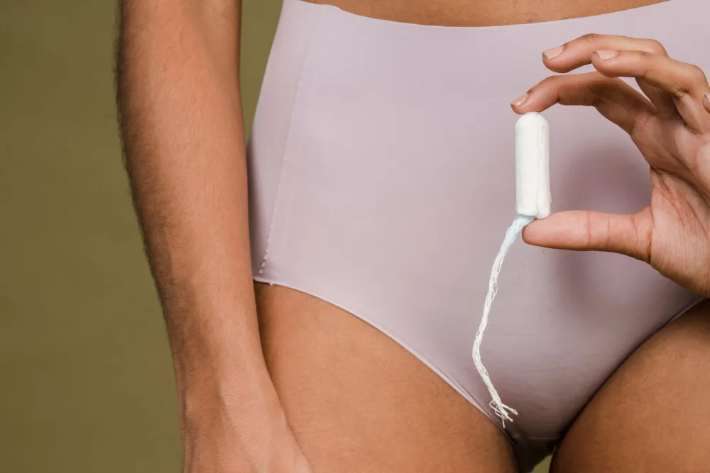 Light pink spotting on a pad illustrating implantation bleeding vs period color difference