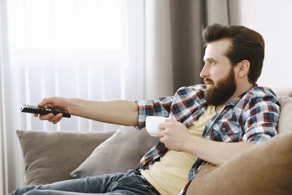 Iv Drips For Hangovers: person lying on couch with hangover symptoms after a night of drinking