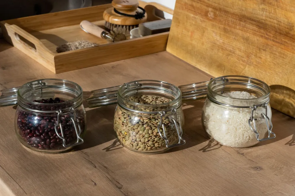 Organized pantry shelf stocked with nuts, oils, and keto food list essentials in glass jars