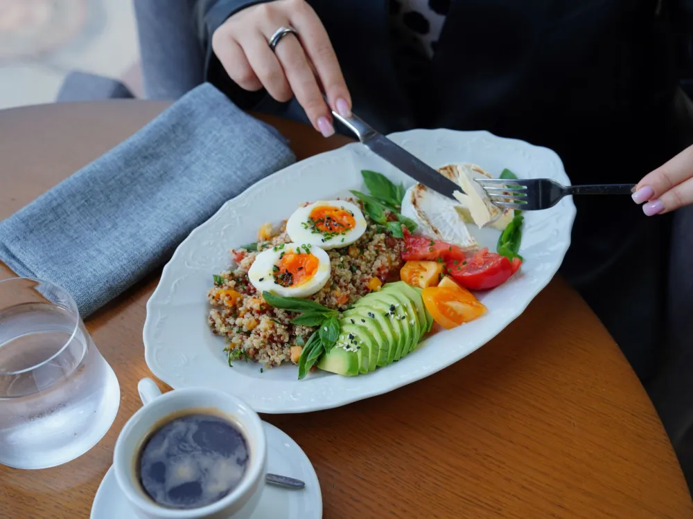 Plate of fried eggs, avocado and spinach showing simple keto meals for beginners