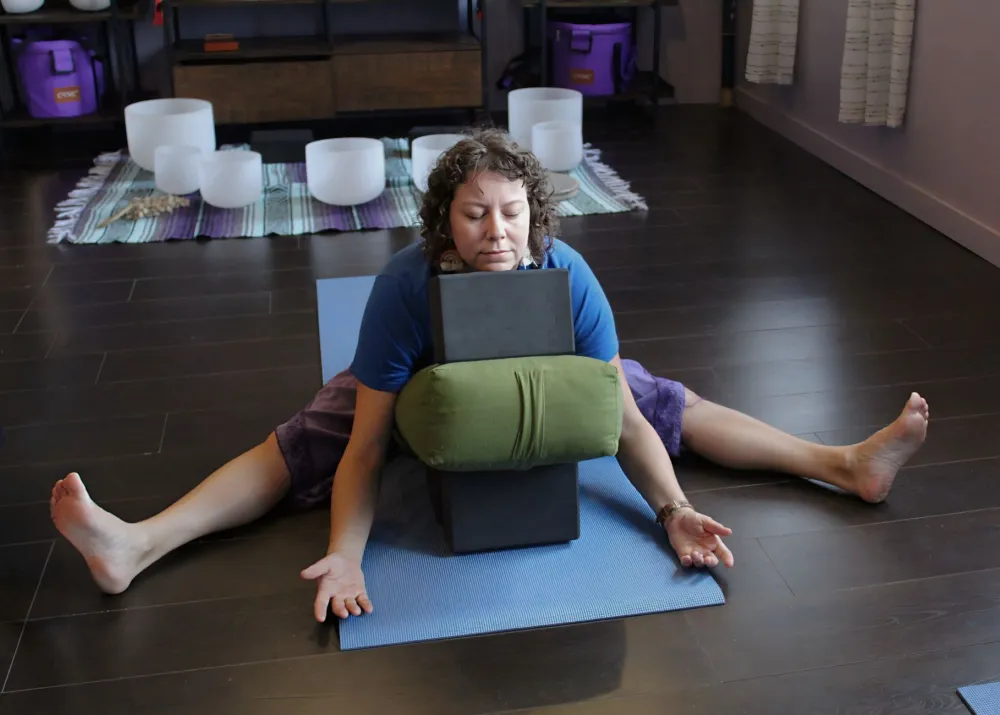 Lower Abdominal Pain in Women: 10 Causes and Warning Signs 4 Woman doing a gentle stretch on a yoga mat at home to ease period cramps