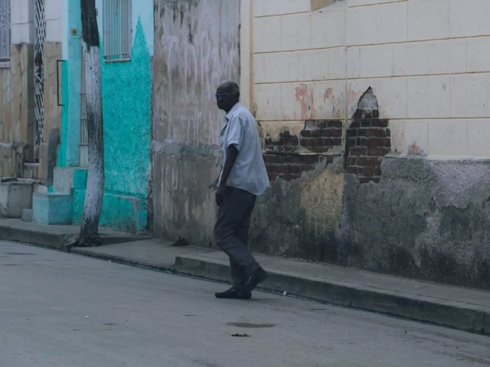 Man walking on a quiet neighborhood street for lower back pain relief