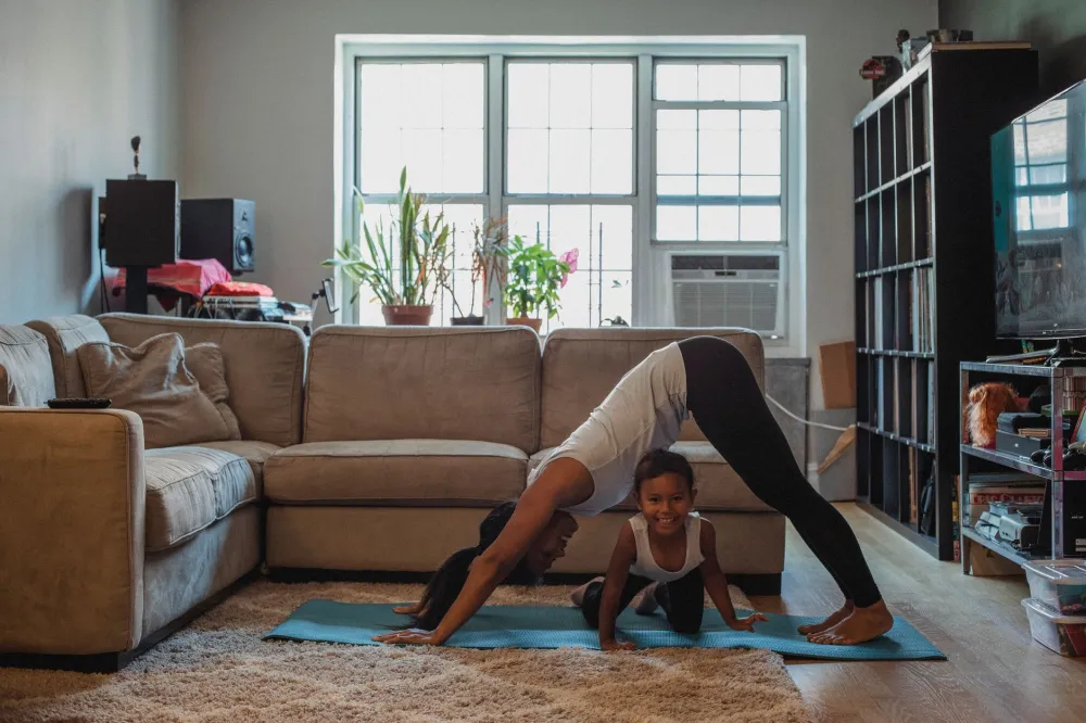 Person doing child's pose yoga stretch for lower back tension relief at home
