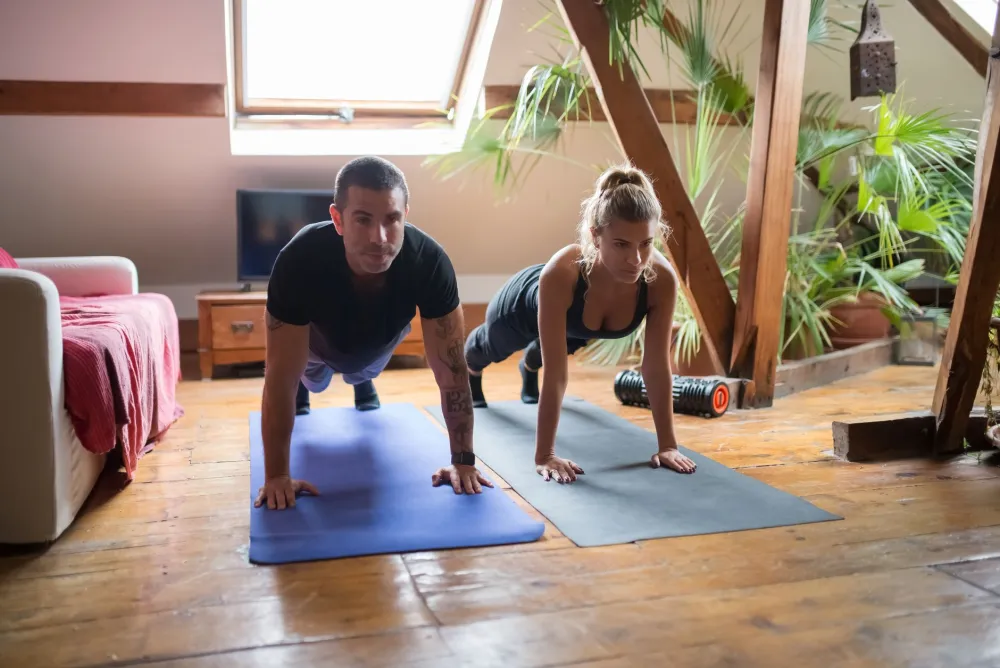 PRP Breast Lift: What It Is, Honest Results and Risks 5 Woman doing push-ups at home to strengthen chest muscles under the breasts