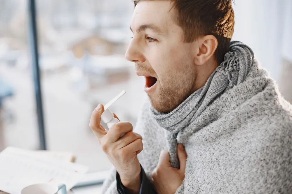 Person gargling warm salt water to soothe gum swelling at home