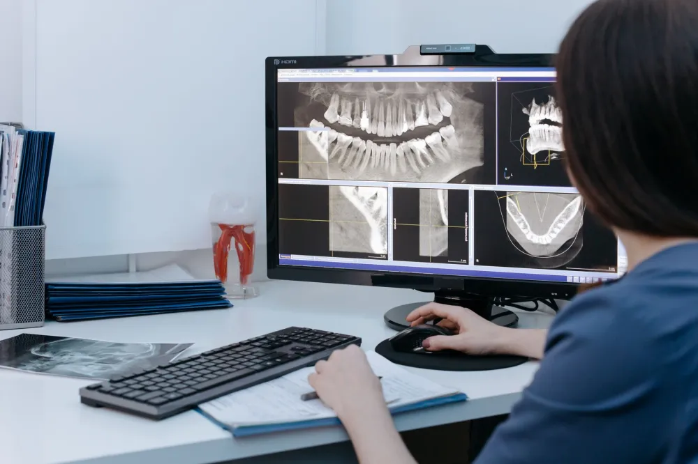 Dentist reviewing X-ray to diagnose the cause of localized gum swelling