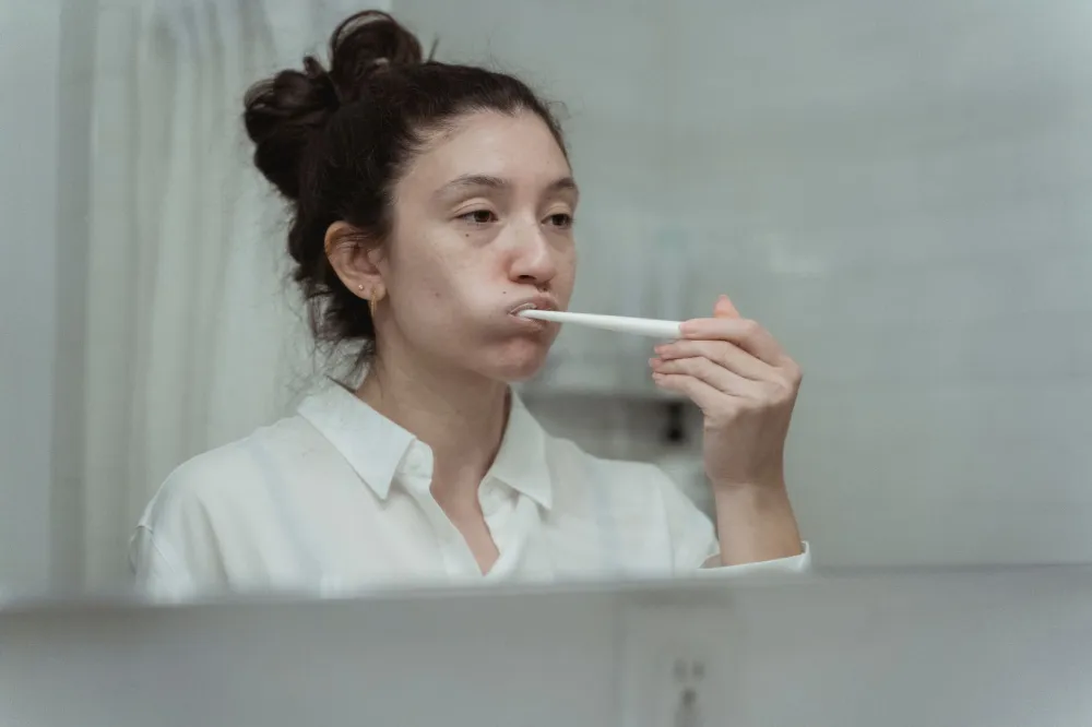 Man brushing teeth carefully to prevent swollen gum around one tooth recurring