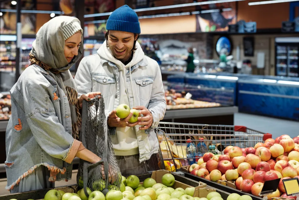 Shopper choosing fresh vegetables and protein foods while budgeting for GLP-1 treatment